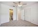 Bedroom with carpeted floors, ceiling fan, and attached bathroom with patterned wallpaper at 4908 S Bedford Ln, Lakeland, FL 33813