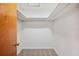 Walk-in closet with an exposed white support beam and beige carpeting at 4908 S Bedford Ln, Lakeland, FL 33813