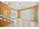 A Foyer featuring tile flooring, staircase with decorative railing, and light fixture at 4908 S Bedford Ln, Lakeland, FL 33813