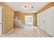 A Foyer featuring tile flooring, staircase with decorative railing, and light fixture at 4908 S Bedford Ln, Lakeland, FL 33813