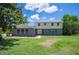 Charming home featuring a mix of brick and vinyl siding, complemented by a well-maintained lawn and mature trees at 4908 S Bedford Ln, Lakeland, FL 33813