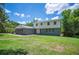 Charming home featuring a mix of brick and vinyl siding, complemented by a well-maintained lawn and mature trees at 4908 S Bedford Ln, Lakeland, FL 33813