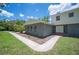 Exterior view of gray home with white trim, multiple windows and walkway leading to the front door at 4908 S Bedford Ln, Lakeland, FL 33813