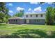 Charming home featuring a mix of brick and vinyl siding, complemented by a well-maintained lawn and mature trees at 4908 S Bedford Ln, Lakeland, FL 33813