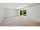 Bright living room with sliding door leading to an outdoor bench and lush backyard at 4908 S Bedford Ln, Lakeland, FL 33813