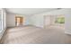 Spacious living room featuring neutral carpet and abundant natural light from large windows at 4908 S Bedford Ln, Lakeland, FL 33813