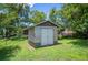 A backyard shed with double doors provides extra storage space for tools and lawn equipment at 4908 S Bedford Ln, Lakeland, FL 33813