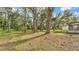 Spacious backyard with mature trees providing ample shade, partially fenced in at 4931 Dove Cross Dr, Lakeland, FL 33810