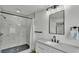 Well-lit bathroom with a black framed shower, vanity and a modern shower head at 4931 Dove Cross Dr, Lakeland, FL 33810
