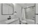 Bathroom with a speckled granite vanity, a black framed mirror, and a tiled bathtub with shower at 4931 Dove Cross Dr, Lakeland, FL 33810