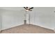 Clean bedroom with ceiling fan, wood-look floor and white doors to closet and other rooms at 4931 Dove Cross Dr, Lakeland, FL 33810