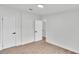 Bright bedroom with laminate flooring, white walls, and black hardware on the doors at 4931 Dove Cross Dr, Lakeland, FL 33810