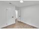Bright bedroom with laminate flooring, white walls, and black hardware on the doors at 4931 Dove Cross Dr, Lakeland, FL 33810