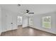 Bright bedroom with wood-look flooring, a ceiling fan, and view to bathroom at 4931 Dove Cross Dr, Lakeland, FL 33810
