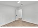 This bedroom features modern laminate flooring, white walls, and black hardware on the doors at 4931 Dove Cross Dr, Lakeland, FL 33810