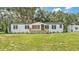 Charming single-story home with a inviting front porch and well-manicured lawn at 4931 Dove Cross Dr, Lakeland, FL 33810