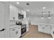 Modern kitchen with stainless steel appliances, white cabinetry, and wood-look floors at 4931 Dove Cross Dr, Lakeland, FL 33810