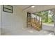 A screened porch provides access to the backyard via wooden stairs from a door at 4931 Dove Cross Dr, Lakeland, FL 33810