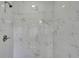 Close-up of a modern shower with large white marble-look tiles at 4931 Dove Cross Dr, Lakeland, FL 33810