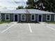 Charming duplex featuring a durable metal roof, dark blue doors, and well-maintained landscaping at 508 & 510 2Nd Sw St, Fort Meade, FL 33841