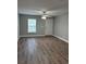 A well-lit living room with a ceiling fan and wood-look floors offers a welcoming space at 508 & 510 2Nd Sw St, Fort Meade, FL 33841