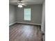 Bright bedroom featuring wood-look vinyl floors, neutral gray paint, and a ceiling fan at 526 & 528 2Nd Sw St, Fort Meade, FL 33841