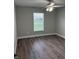 Bedroom featuring new gray paint, wood-look vinyl floors, and a window for natural light at 526 & 528 2Nd Sw St, Fort Meade, FL 33841