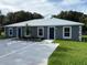 New construction home featuring a manicured lawn, modern metal roof and designated parking spaces at 526 & 528 2Nd Sw St, Fort Meade, FL 33841