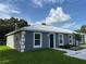 Charming gray home with a modern metal roof, a freshly manicured lawn, and blue skies at 526 & 528 2Nd Sw St, Fort Meade, FL 33841