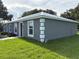 The exterior of the home features a modern metal roof, gray stucco walls, and green grass at 526 & 528 2Nd Sw St, Fort Meade, FL 33841