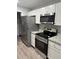Modern kitchen with stainless steel appliances, white cabinets, and granite countertops at 526 & 528 2Nd Sw St, Fort Meade, FL 33841