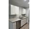 Bright kitchen with stainless steel dishwasher, double sink, granite countertops, and white cabinets at 526 & 528 2Nd Sw St, Fort Meade, FL 33841