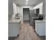 The modern kitchen features stainless steel appliances, white cabinets and granite countertops at 526 & 528 2Nd Sw St, Fort Meade, FL 33841
