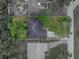 Aerial view of a well-maintained home with dark roof with surrounding green trees at 5522 1St Se St, Lakeland, FL 33812