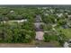 Birds eye view of a home with a dark roof nestled in a wooded community at 5522 1St Se St, Lakeland, FL 33812