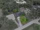 Aerial view of property showcasing the home's layout, surrounding trees, and lot boundaries at 5522 1St Se St, Lakeland, FL 33812