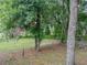 Mature trees provide ample shade and privacy for the back yard, with a wooden lattice fence at 5522 1St Se St, Lakeland, FL 33812