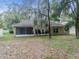 Backyard with mature trees, a screened in porch, and lots of leaf coverage at 5522 1St Se St, Lakeland, FL 33812