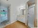 Bathroom featuring a vanity with white cabinets and a glass door shower at 5522 1St Se St, Lakeland, FL 33812