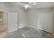 Bedroom with neutral walls, ceiling fan, closet, and large window at 5522 1St Se St, Lakeland, FL 33812