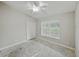 Bedroom with neutral walls, ceiling fan, and a large window at 5522 1St Se St, Lakeland, FL 33812