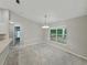 Bright dining room featuring a modern chandelier and a large window offering a serene outdoor view at 5522 1St Se St, Lakeland, FL 33812