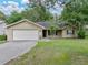 Charming single-Gathering home featuring a two-car garage, a well-maintained lawn, and mature trees at 5522 1St Se St, Lakeland, FL 33812