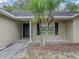 The front entryway has a walkway and a palm tree next to the front window at 5522 1St Se St, Lakeland, FL 33812