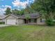 Picture of a cozy one-story home with a manicured lawn and brick driveway at 5522 1St Se St, Lakeland, FL 33812
