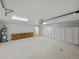 Spacious two car garage featuring ample storage cabinets, lighting and work bench at 5522 1St Se St, Lakeland, FL 33812