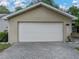 Two-car garage with a brick paver driveway and well-manicured landscaping enhancing curb appeal at 5522 1St Se St, Lakeland, FL 33812