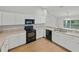 Well-lit kitchen with white cabinets, sleek appliances, and a functional design at 5522 1St Se St, Lakeland, FL 33812