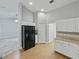 Bright kitchen featuring white cabinets and a modern black refrigerator at 5522 1St Se St, Lakeland, FL 33812