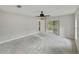 Main bedroom featuring a sliding glass door to a screened patio, enhancing indoor/outdoor living at 5522 1St Se St, Lakeland, FL 33812